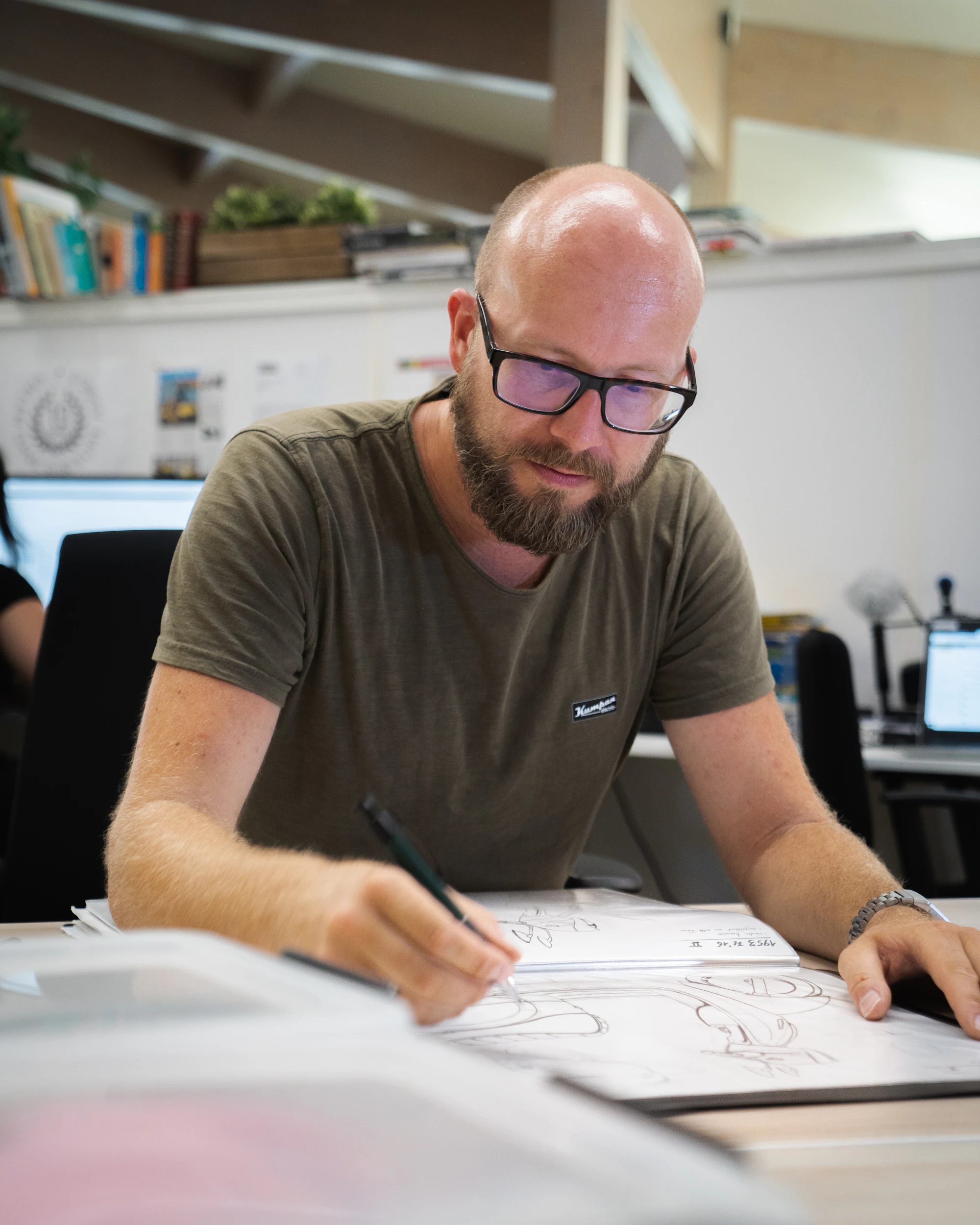 A RhythmRx engineer and a client reviewing a device design together at a bench.